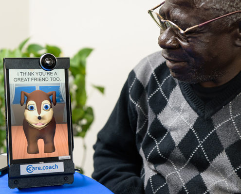 senior man at element care talks to his avatar for medication reminder