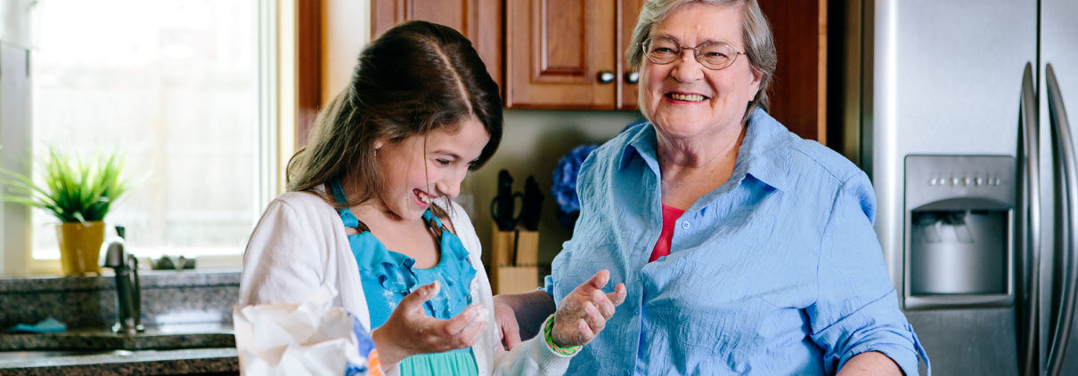 senior woman cooking with her granddaughter